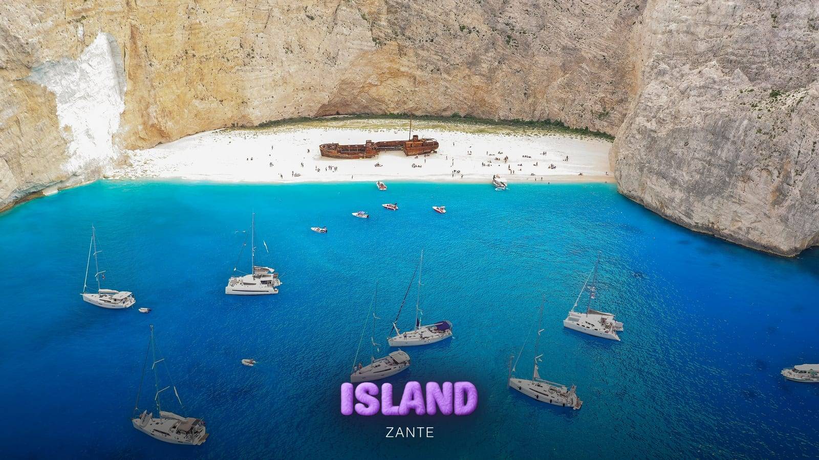 Sailing boats anchored in the turquoise cove of Navagio (Shipwreck Beach), Zante, seen from the air