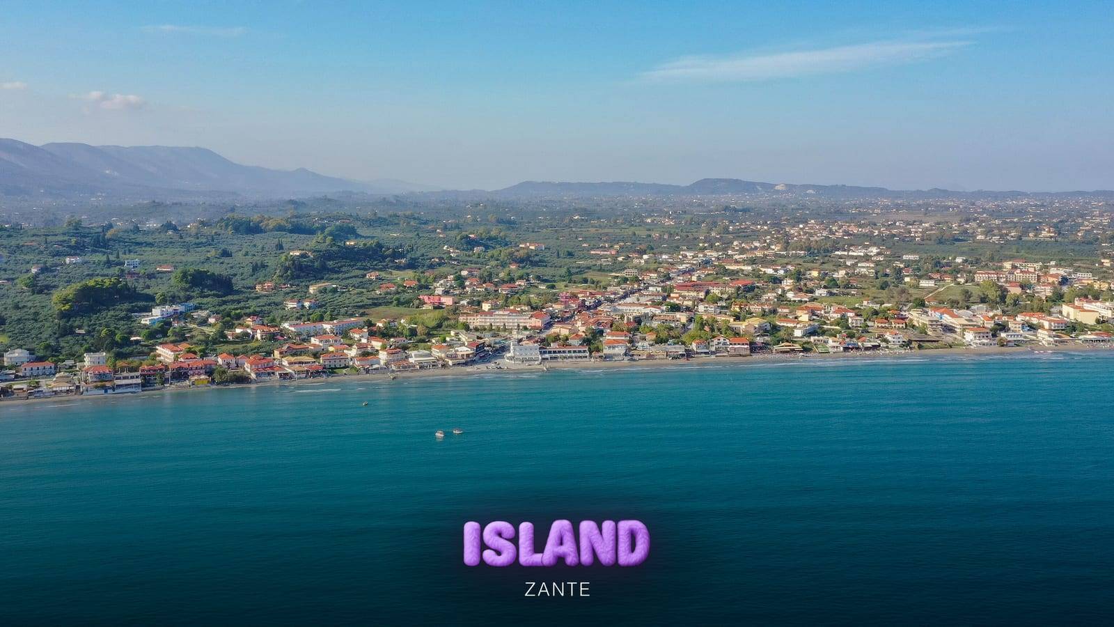 Laganas Bay, Zante, from the air: the resort along the beach, turquoise water and the hills behind