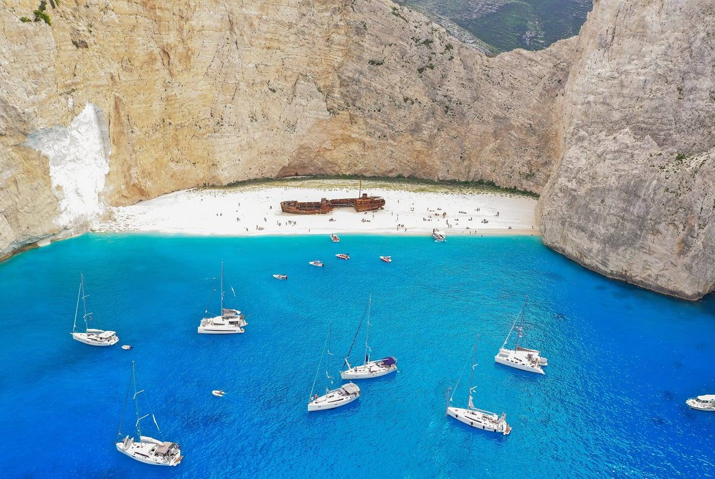 Sailing boats anchored in the cove of Navagio (Shipwreck Beach), Zante, seen from the air